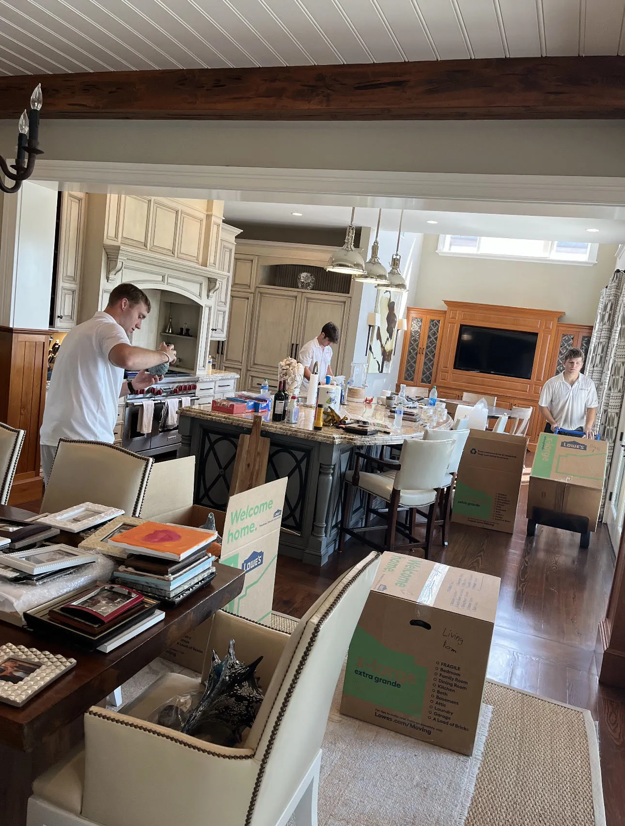 T&T crew members packing dishes in a customer's kitchen