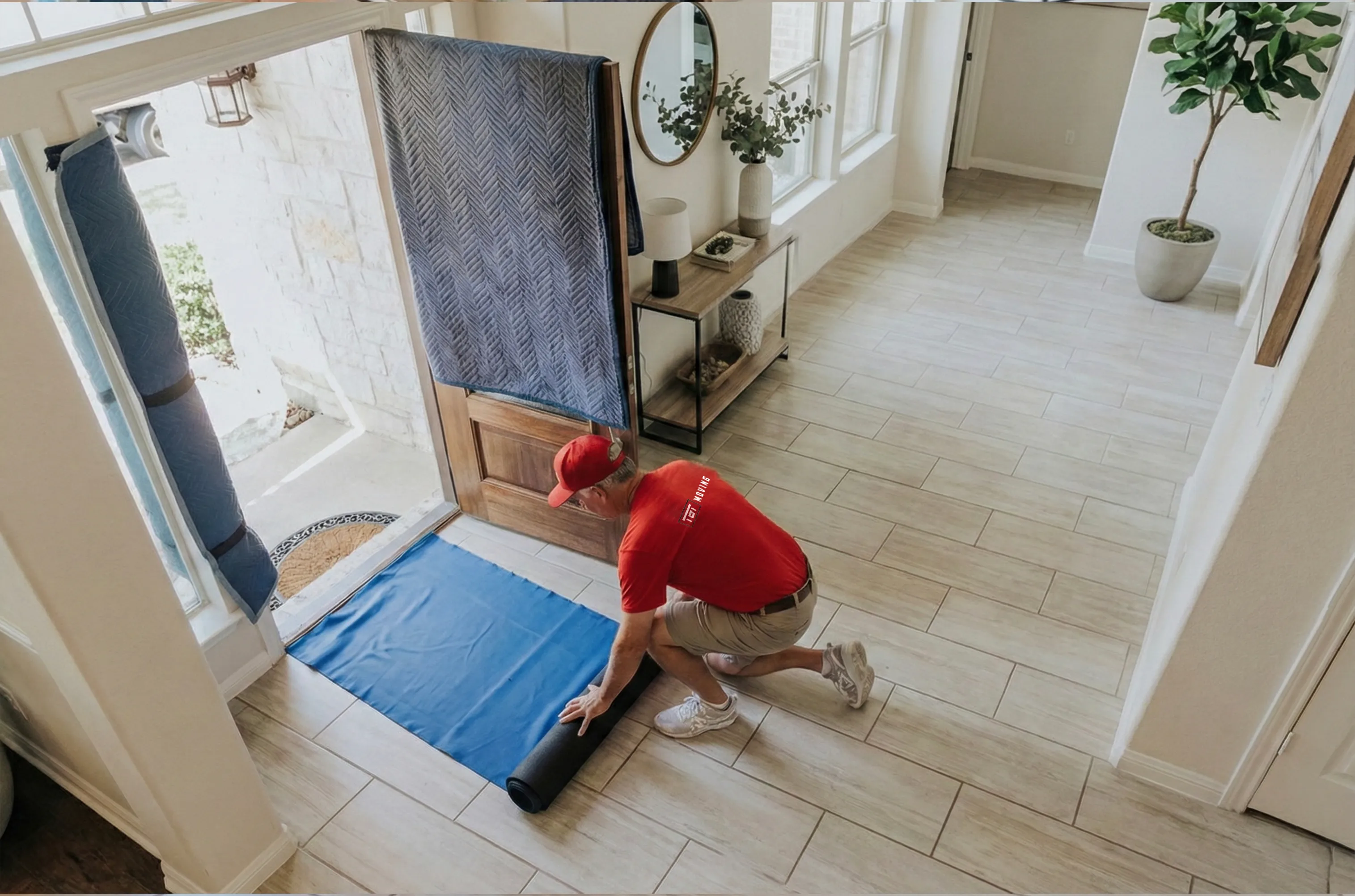A mover rolling out floor protection in an office entryway